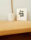 Sign, Live Laugh Love on wooden shelf, modern decoration in retro home