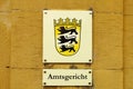 A sign at the local court german: Amtsgericht in a city of Baden-Wuerttemberg with the emblem of Baden-Wuerttemberg