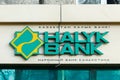 A sign with the logo of Halyk Bank over the entrance of a small branch of the bank