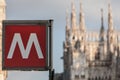 sign logo metro station in Milan Italy with blurred church on the background