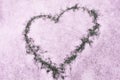 Sign of love-heart painted on snow, pastel pink background, Valentine's day Royalty Free Stock Photo