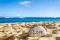 Sign Love on the sandy beach