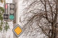 Sign main road and traffic light against the gray winter sky Royalty Free Stock Photo