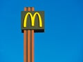 Sign mc donald logo against clear blue sky Royalty Free Stock Photo