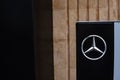 Sign of Mercedes benz on a black stele at the entrance to a car store selling cars 10.11.2020 in Russia, Kazan, Moskovskaya street