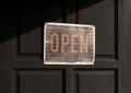 Sign with message Welcome OPEN on black wooden door Royalty Free Stock Photo