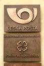 A sign on metal plate, inscription in Czech - Czech Post, Czechoslovak Commercial Bank, Postal Savings Bank.Postal logo, Czech