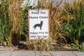 Sign in neighborhood with the label  `Keep your home clean - always pick up after your dog.` Royalty Free Stock Photo