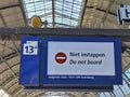 A sign Niet instappen or do not board at a train station in the netherlands Royalty Free Stock Photo