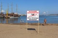 Sign No swimming! Zone passage of ships on background of people bathing at berth in Gelendzhik