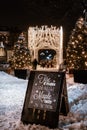 A sign offering Maple taffy on the snow in the place Jacques-Cartier in Old Montreal with Christmas lights and winter decorations Royalty Free Stock Photo