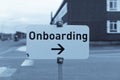 Sign `Onboarding` with arrow to the right side monochromatic filtered