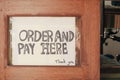 Sign order and pay here sign used in restaurants and coffee cafe Royalty Free Stock Photo