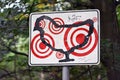 Sign with outlines of a chicken with multiple red target marks on it as part of art exhibition in forest