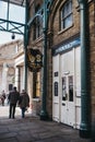 Sign outside closed doors of Punch & Judy pub in Covent Garden Market, London, UK, people walking past