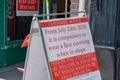 A sign outside of a shop ensuring that people wear face masks in shops as part of new UK government regulations due to Covid