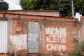 A sign painted on the front of a poor house that reads For sale or will trade for a Car Royalty Free Stock Photo