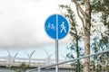 Sign for pedestrians and cyclists near a road in the park. Close up shot.Bicycle and Walking Path Sign with Sky Royalty Free Stock Photo