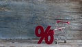 sign percent and shopping cart on wood background Royalty Free Stock Photo