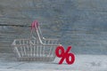 sign percent and shopping cart on wood background Royalty Free Stock Photo