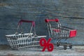 sign percent and shopping cart on wood background Royalty Free Stock Photo