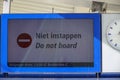 Sign at platform with \'Do not board\' or Niet Instappen in Dutch Royalty Free Stock Photo