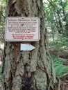 Sign on a tree in a forest