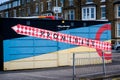 Sign pointing to Morecambe promenade painted on a building