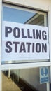 Sign for Polling Station in election, positioned in a glass window