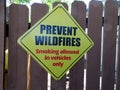 A sign requesting prevention of wildfires showing smoking allowed in vehicles only