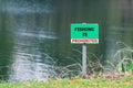 A sign prohibiting fishing in the pond