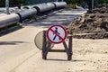 A sign prohibiting pedestrians from passing on the road. installation of the pipeline.