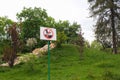 Sign prohibiting walking on the lawn. White plate with foot in a black boot, walking on green grass. Forbiddance Royalty Free Stock Photo