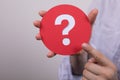 Sign of the question mark made of red paper in the hands of a man Royalty Free Stock Photo