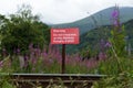 Sign on the railway tracks with the English text: Warning Do not trespass on the Railway penalty pound 1000