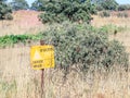 A sign reading `Danger Mines!` hangs from a barbed wire fence in the Golan Heights, near the border with Syria, Israel Royalty Free Stock Photo