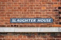 A Sign reading Slaughter house on a brick building