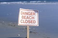 A sign reads danger beach closed Royalty Free Stock Photo