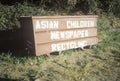 A sign that reads Ã¯Â¿Â½Asian Children Newspaper RecyclingÃ¯Â¿Â½
