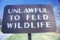 A sign that reads Ã¯Â¿Â½Unlawful to feed wildlifeÃ¯Â¿Â½