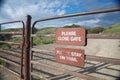 Sign reminds visitors to close the gate Royalty Free Stock Photo