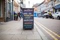 Sign with restaurant menu on the tiled sidewalk