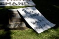 A Sign Rests on a City Hall Plaque at Occupy L.A. Royalty Free Stock Photo