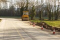 Sign at roadworks and compactor asphalt