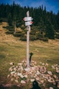 A sign on a rock a grassy hill Royalty Free Stock Photo