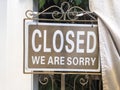 Sign saying: Closed. We are sorry. On brown background