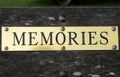 A sign saying `memories` on a wooden bench