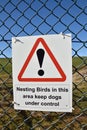Sign saying nesting birds in this area keep dogs under control