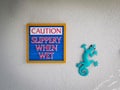 sign saying slippery when wet, caution. typical craft artwork de
