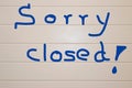 Sign saying `Sorry closed` on a light background